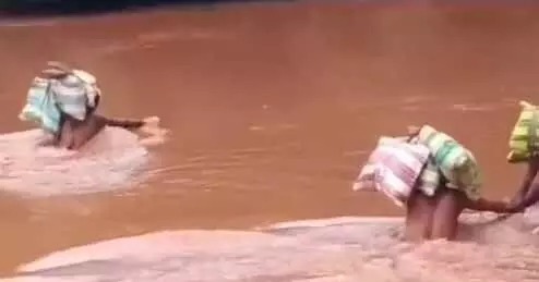 River and drain are in spate, people crossing the spate without caring for their lives, watch video